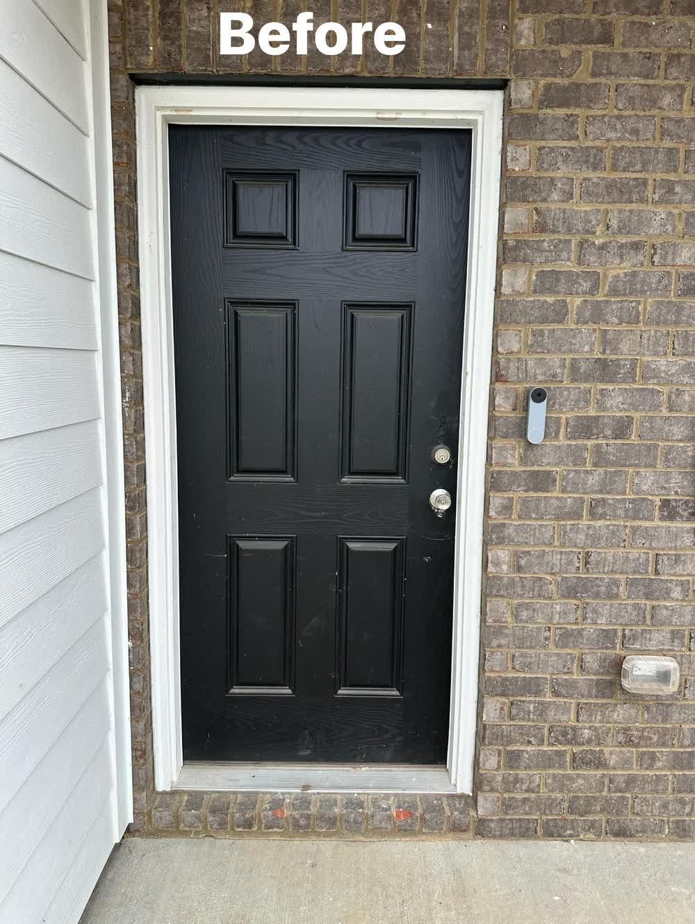 Old worn black exterior door before replacement